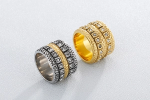 Macro detail of wide hammered stainless steel rings with sparkling cubic zirconia inlay