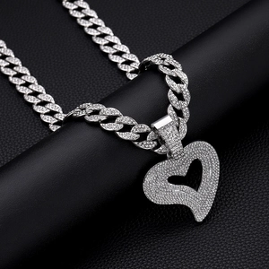 Macro shot of silver hip-hop heart pendant with sparkling rhinestones on Cuban chain