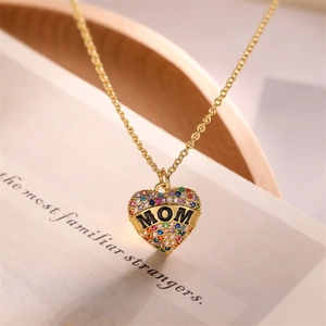 Macro shot of gold-plated MOM heart pendant with colorful zircon stones on a book