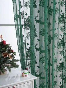 Texture détaillée de la dentelle du rideau de Noël vert foncé avec motifs de rennes