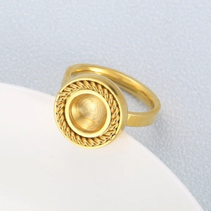 Macro detail of a vintage golden grooved ring with a twist texture on a white plate