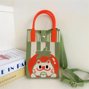 Detail view of knitted crossbody bag with tomato cat pattern and magnetic buckle