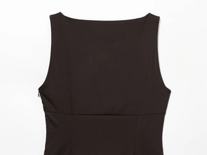 Detail of black sleeveless dress showing the boat neck and hidden side zipper closure
