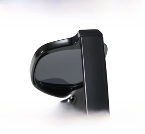 Detailed close-up of firm hinges and textured temples on glossy black square sunglasses