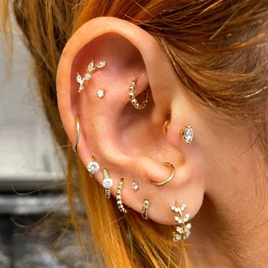 Detail of S925 sterling silver ear cuff set with gold leaf designs and zircon accents