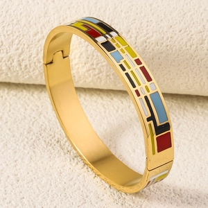 Detail of 18K gold-plated stainless steel bangle with colorful enamel geometric patterns