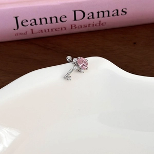 Macro detail of a pink star bow heart stud earring with micro-set zircons on ceramic