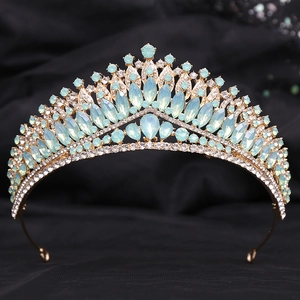 Macro detail of golden bridal tiara featuring light blue opal-style gems and white crystals