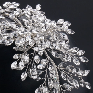 Detail of silver wire bridal hairpiece with clear leaf crystals and floral patterns