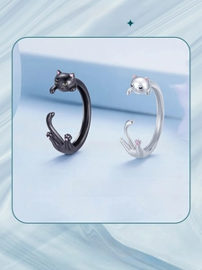Close-up of black and silver S925 sterling silver cat open rings with pink paw details