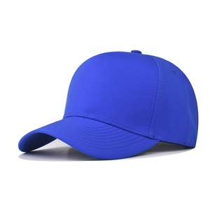 Close-up of royal blue five-panel baseball cap showing smooth synthetic fabric and curved brim