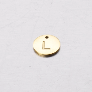 Close-up of golden 12mm stainless steel round pendant charm with engraved letter L
