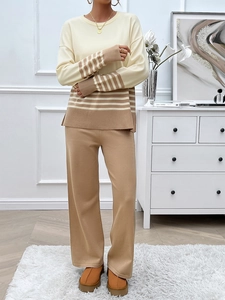 Detail of beige and khaki striped knitwear top paired with stylish wide-leg trousers