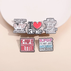 Set of 5 K-Pop themed enamel pins with colorful text designs on pink background