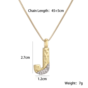 Close-up of golden letter J pendant necklace with zircon inlay and product dimensions