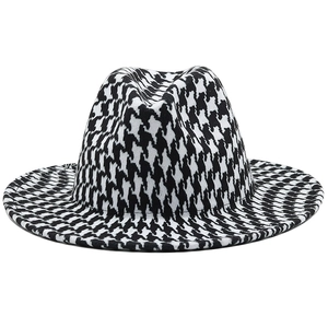 Classic black and white houndstooth wool fedora hat with a flat brim and retro British style