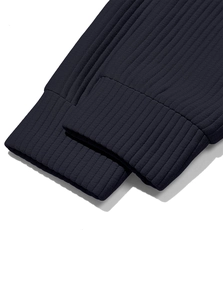 Detailed macro view of the ribbed knit cuffs on a navy blue corduroy sweatshirt