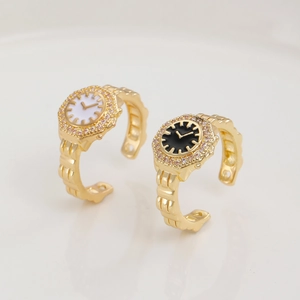 Detail of adjustable watch rings in gold finish with white and black dials and crystals