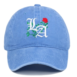 Detail of Gothic LA letter and red rose embroidery on washed blue denim baseball cap