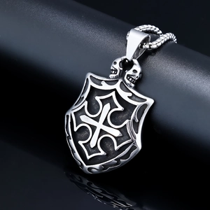 Gothic stainless steel shield necklace with cross and skulls on a sleek black pedestal