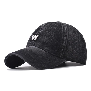 Detail view of retro washed denim baseball cap featuring a white 3D embroidered W letter