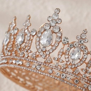 Macro detail of luxury baroque crown featuring iridescent AB rhinestones and gold plating