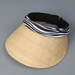 Close-up of raffia straw sun visor with zebra pattern headband and woven texture