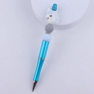 Detailed view of a blue DIY beaded ballpoint pen with a cute unicorn silicone topper