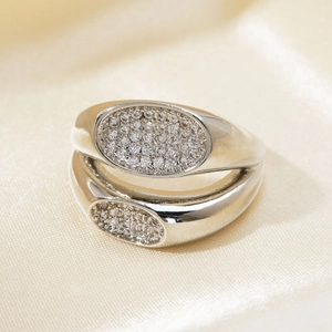 Macro shot of silver double-layered ring featuring micro-pave cubic zirconia on silk