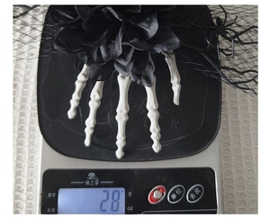 Detailed view of Halloween gothic skeleton hand hair clip with black rose weighing 28g
