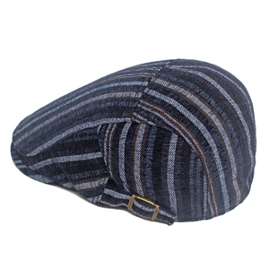 Detailed close-up of retro striped flat cap featuring the adjustable bronze metal side buckle
