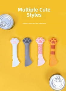Cat paw silicone pet food spoons in four colors on a yellow background with cans
