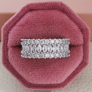 Luxury silver marquise and round cut zircon eternity band ring in a pink velvet jewelry box