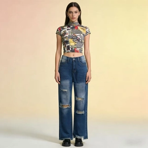 Detail shot of vintage dark blue straight jeans with knee rips and frayed hem design