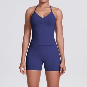 Macro detail of dark blue yoga set showing ribbed waistband and v-neck halter top