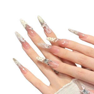 Sweet pink and white stiletto press-on nails with 3D bows, rhinestones, and pearls