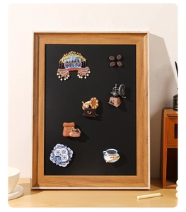 Detailed close-up of decorative coffee beans and phonograph magnets in a wooden frame