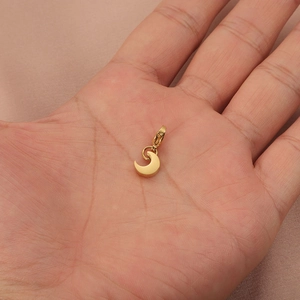 Golden moon pendant with lobster clasp displayed on a hand with minimalist stainless steel design