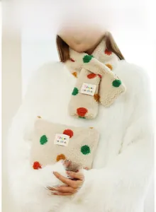 Close-up of soft cream lamb wool scarf and pouch set with vibrant colored polka dots