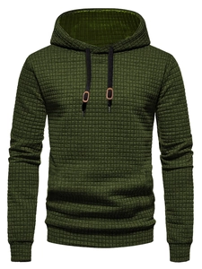 Close-up of olive green hoodie with waffle texture and brown leather drawstring detail
