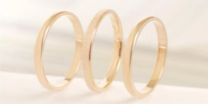 Detailed view of three stackable titanium steel rings with polished and frosted finishes