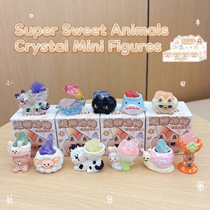 Macro shot of assorted crystal animal figurines including cats and rabbits on wood