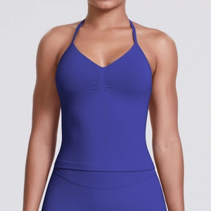 Detail of royal blue seamless sports halter top featuring pleated front and ribbed hem
