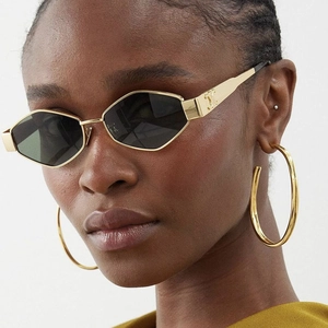Fashionable geometric gold metal sunglasses with dark lenses and oversized hoop earrings
