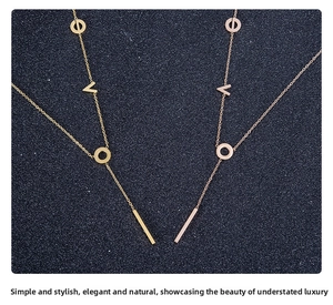 Detailed view of titanium steel necklaces with LOVE letters and bar charms in gold finishes