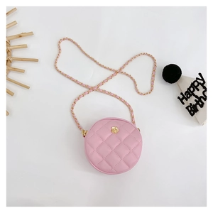 Pink quilted round mini crossbody bag with gold flower clasp and birthday party props