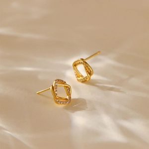 Square interlaced gold earrings with zircon inlay shown in a luxury close-up view