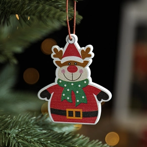 Wooden Christmas reindeer ornament hanging on a pine tree with warm bokeh festive lights
