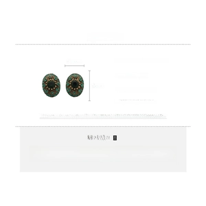 Detailed specs of vintage oval earrings with green crystals and bronze-tone base