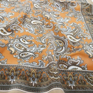 Orange paisley print square neck scarf in silky fabric for hair styling and accessory
